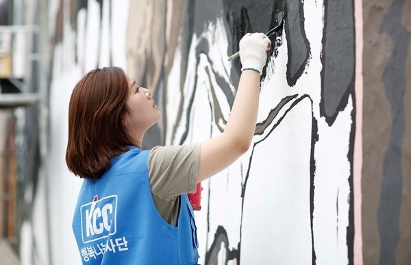 KCC 사내 봉사활동 동호회 직원이 자사의 친환경 페인트를 사용해 벽화를 그리고 있다. (사진제공=KCC)